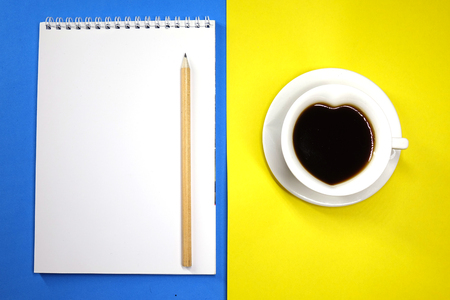 Notepad and coffee on colored background top view, businessの写真素材