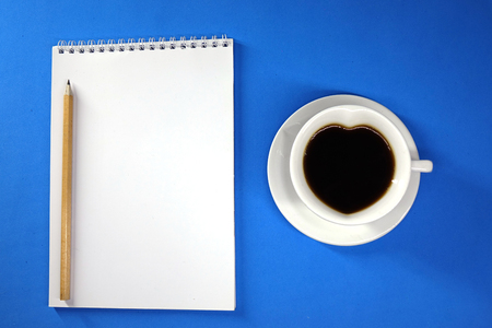 Notepad and coffee on colored background top view, businessの写真素材
