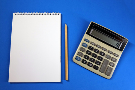 Notepad, pencil and calculator on colored background top view, school, business, education, knowledgeの写真素材