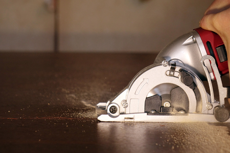 Electric jigsaw cuts chipboardの写真素材