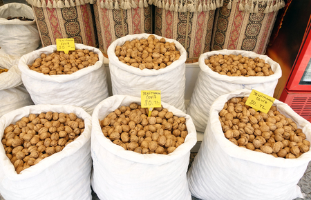 Walnuts in a white bag at the market. Trade.の写真素材