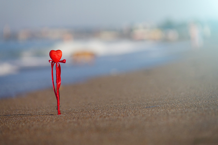 Red heart on the beach.Valentine's day greeting card concept, red heart on pristine sandy beach, honeymoon vacation background.の写真素材