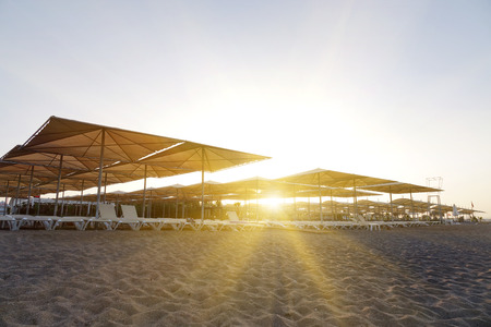 Sun loungers with umbrella on the beach. Tourism industry. relaxationの写真素材