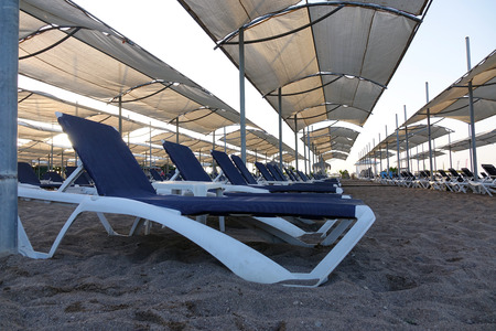Sun loungers with umbrella on the beach. Tourism industry. relaxationの写真素材