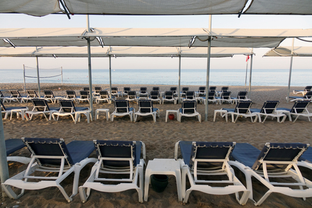 Sun loungers with umbrella on the beach. Tourism industry. relaxationの写真素材