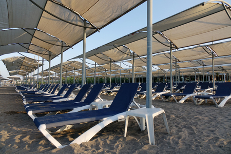 Sun loungers with umbrella on the beach. Tourism industry. relaxationの写真素材