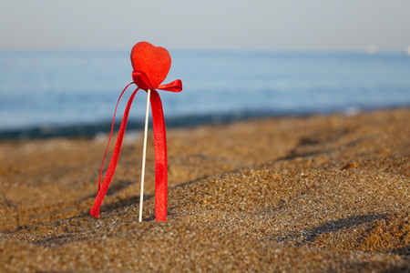 Red heart on the beach.Valentine's day greeting card concept, red heart on pristine sandy beach, honeymoon vacation background.の写真素材
