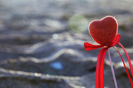 Red heart on the beach.Valentine's day greeting card concept, red heart on pristine sandy beach, honeymoon vacation background.の写真素材