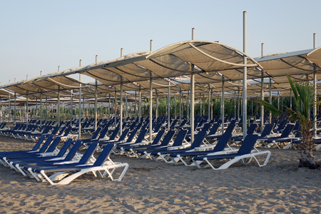 Sun loungers with umbrella on the beach. Tourism industry. relaxationの写真素材