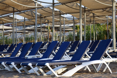 Sun loungers with umbrella on the beach. Tourism industry. relaxationの写真素材