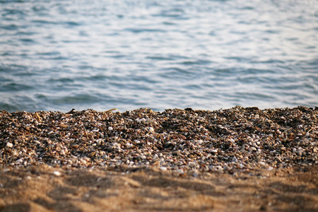 Pebble beach and blue sky on background.sea, rock