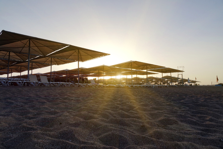 Sun loungers with umbrella on the beach. Tourism industry. relaxationの写真素材