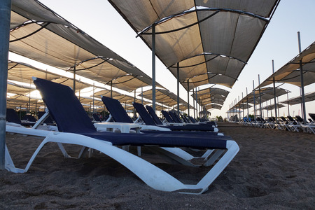 Sun loungers with umbrella on the beach. Tourism industry. relaxationの写真素材