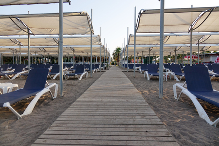 Sun loungers with umbrella on the beach. Tourism industry. relaxationの写真素材