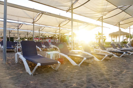 Sun loungers with umbrella on the beach. Tourism industry. relaxationの写真素材
