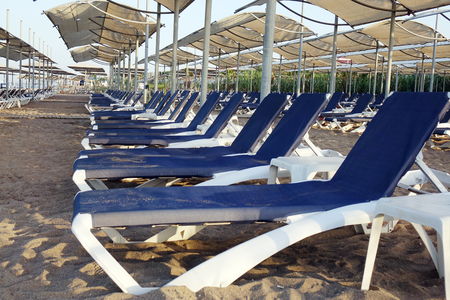 Sun loungers with umbrella on the beach. Tourism industry. relaxationの写真素材