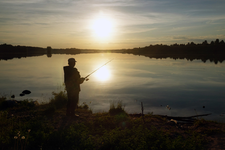 Fisherman silhouette at sunset. hobbyの写真素材