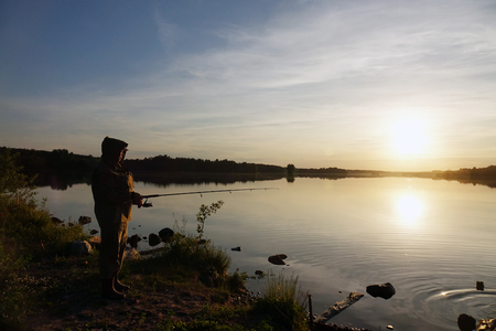 Fisherman silhouette at sunset. hobbyの写真素材