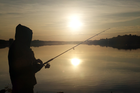Fisherman silhouette at sunset. hobbyの写真素材