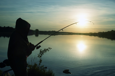 Fisherman silhouette at sunset. hobbyの写真素材