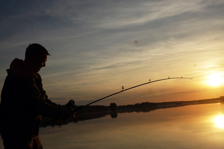Fisherman silhouette at sunset. hobbyの写真素材