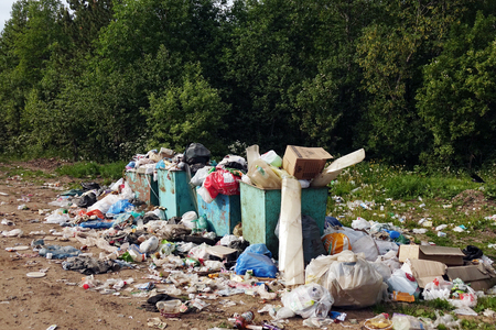 Russia, lake Onega region-June 2018. Crowded bins with garbage near the forest .のeditorial素材