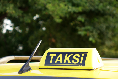 Taxi car roof sign on bokeh background in Istanbul of Turkeyの写真素材