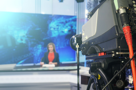 The news presenter reads the text on the teleprompter.Camera in the office. TV studio. Actual events.の写真素材