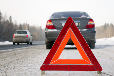 The emergency stop sign.Red sign emergency stop in the snow, on the road.の写真素材