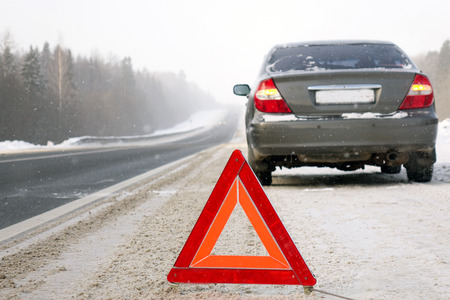 The emergency stop sign.Red sign emergency stop in the snow, on the road.の写真素材
