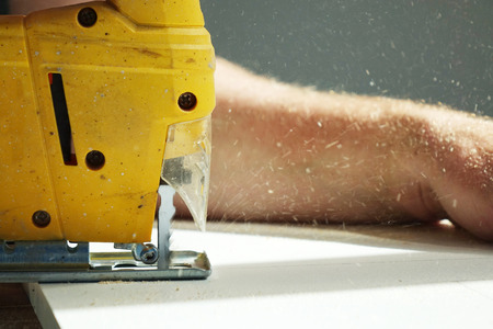 Working with an automatic electric saw works in a carpentry workshop. The concept of handmadeの写真素材