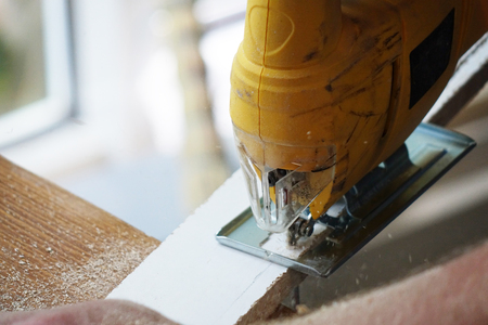Working with an automatic electric saw works in a carpentry workshop. The concept of handmadeの写真素材