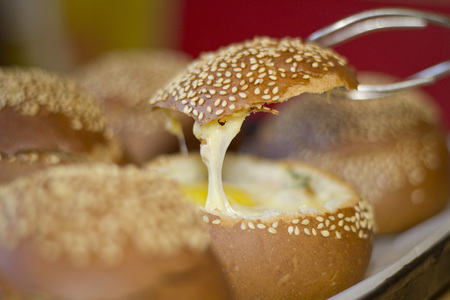 Buns with liquid egg, bacon and melted cheese.Egg, cheese and bacon sandwiches. Hot breakfast