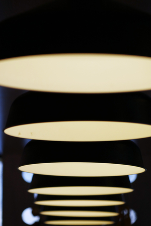 Lamps in a row. Light show. Ceramic lamps with light bulbsの写真素材