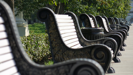 Cast iron benches with wooden slats for seatsの写真素材