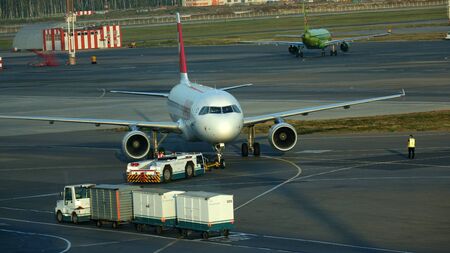 Moscow. Russia-September 2018: the Loading of cargo into the plane at the airport, the view through the windowのeditorial素材