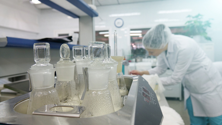 A female laboratory assistant checks samples of dairy products in the laboratory.の写真素材