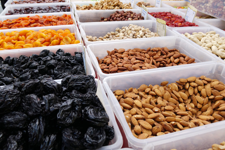 Dried fruit background. Rows of dried dates, apricots,cranberries, pomelos, blueberries, nuts prunes and figsの写真素材