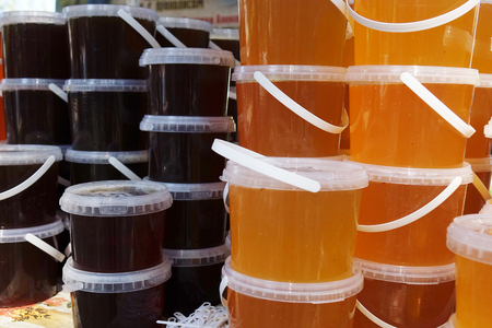Banks with different kinds of honey in the marketの写真素材