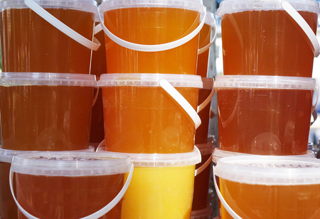 Banks with different kinds of honey in the marketの写真素材