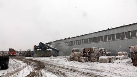 Loading the container with waste on a special machine .Recycling plant. Waste sorting and recycling businessの写真素材