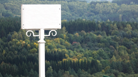 White blank sign on a forest background. Warning sign.