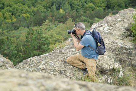 Nature photographer takes pictures in the mountains..の写真素材