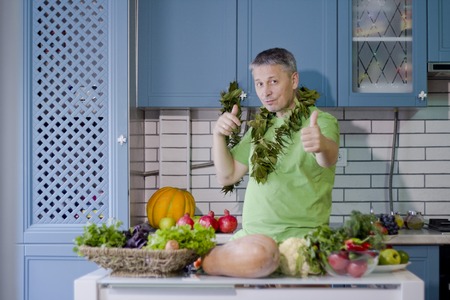 A man in the kitchen prepares vegetarian dishes. Vegetables , ready for cooking.の写真素材
