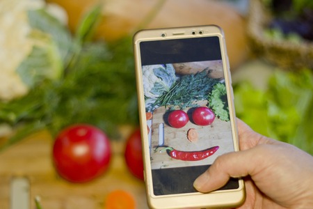 Photographing vegetables on the phone. Photo still life in the form of smiles.の写真素材