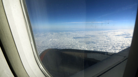 Clouds and sky as seen through window of an aircraft.の写真素材