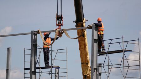 Construction of the shop of metal .Workers and equipment on the construction site.の写真素材