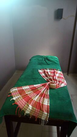 Green massage table with towel. A place to relax in the modern Wellness centre.の写真素材