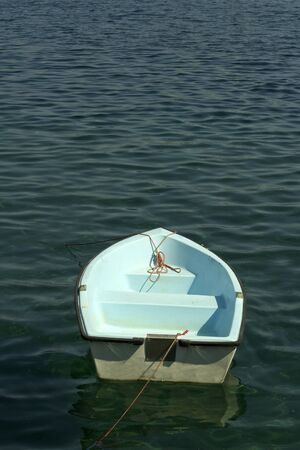 A small white boat on the water.の写真素材