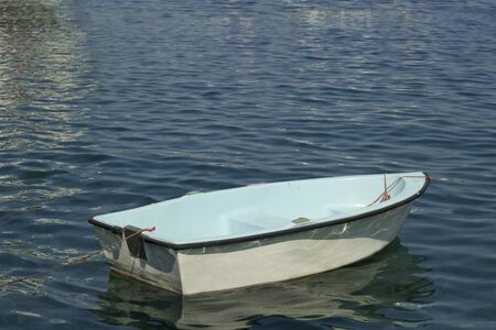 A small white boat on the water.の写真素材